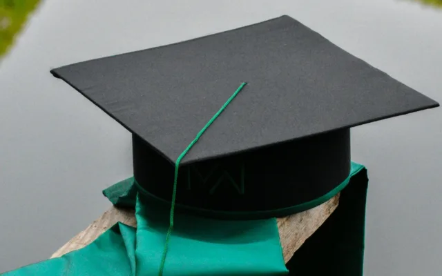 A graduation cap and gown illustrating student loans and college financing.